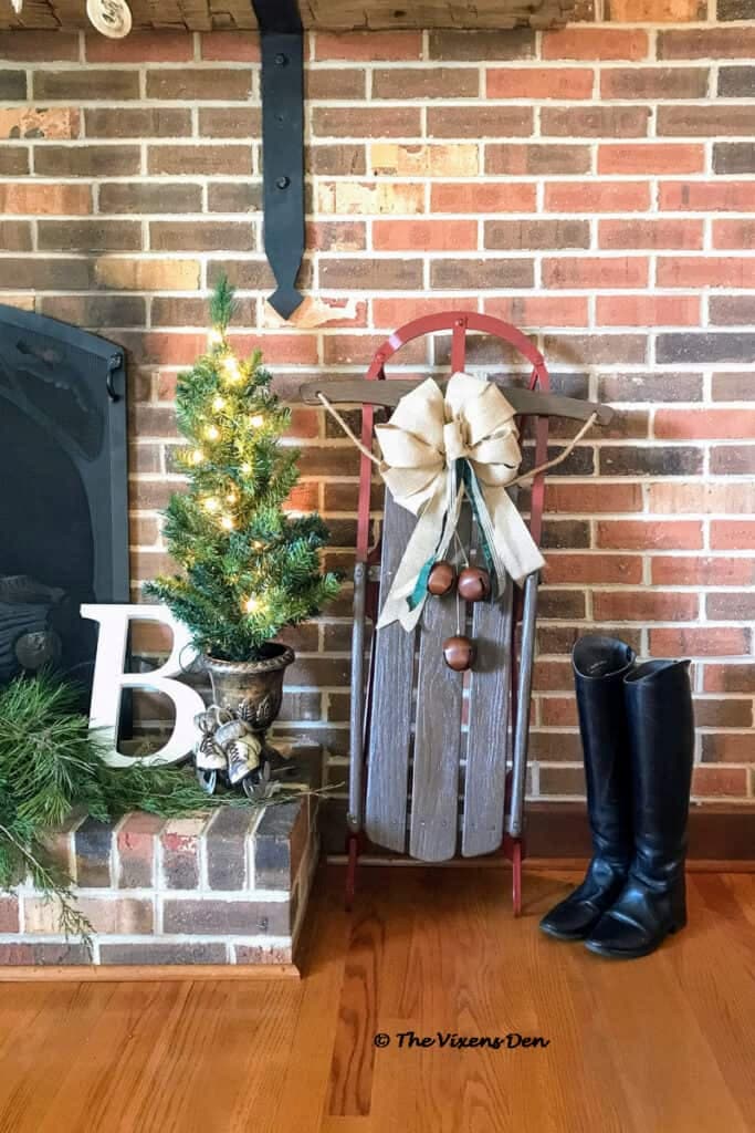 a vintage sled by a fireplace