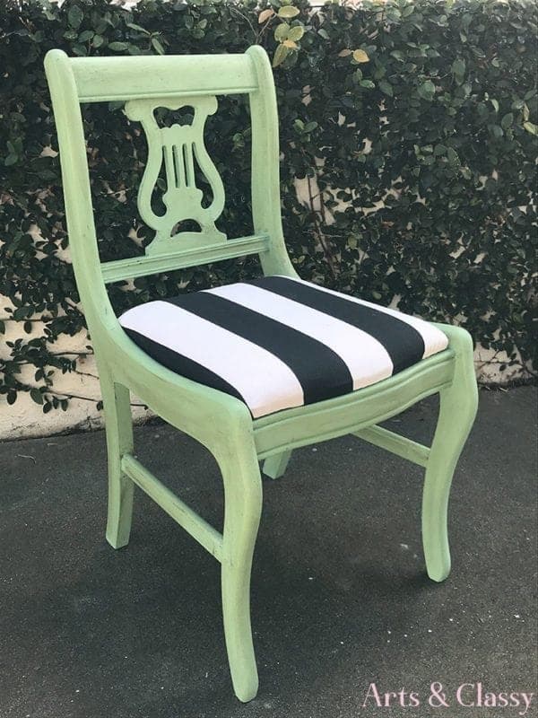 green chair with black and white striped seat