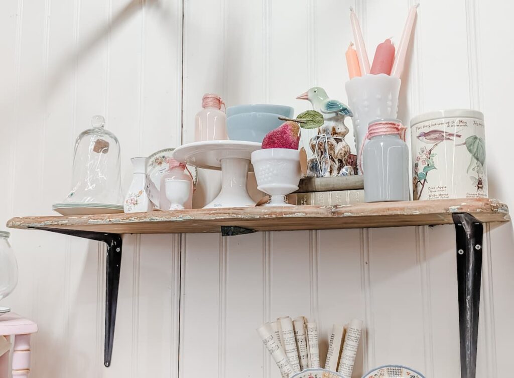 shelf of vintage pastel home decor