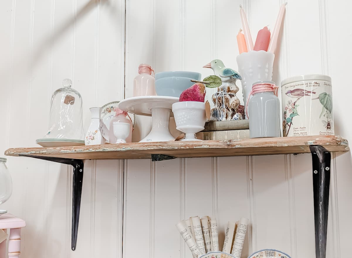 shelf of vintage pastel home decor