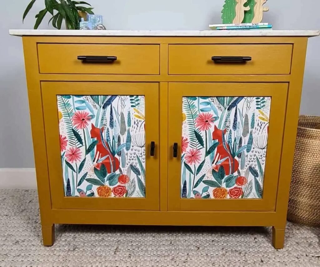 Yellow cabinet with wallpaper details