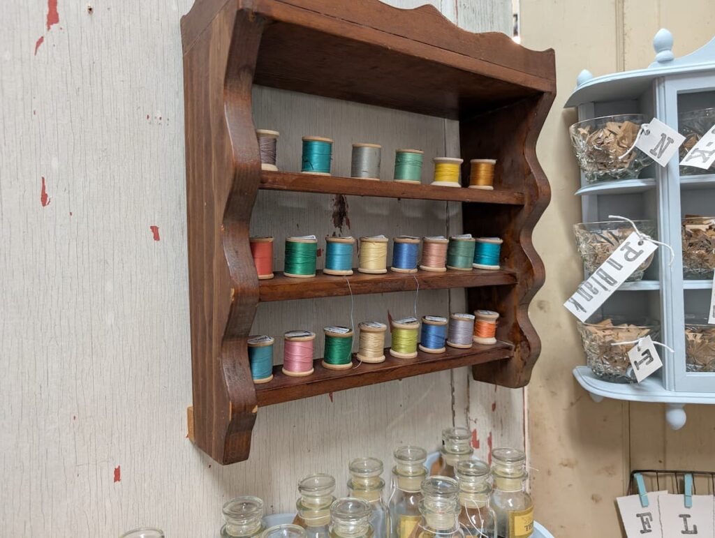 Spools of thread in wood display