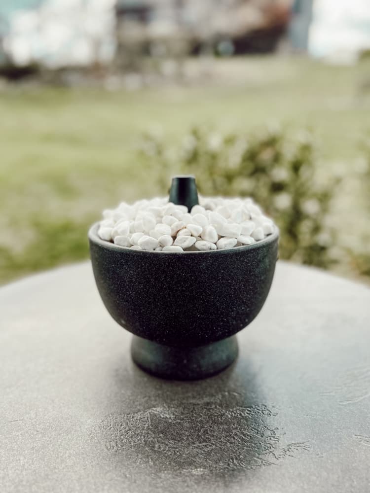 black bowl with white rocks