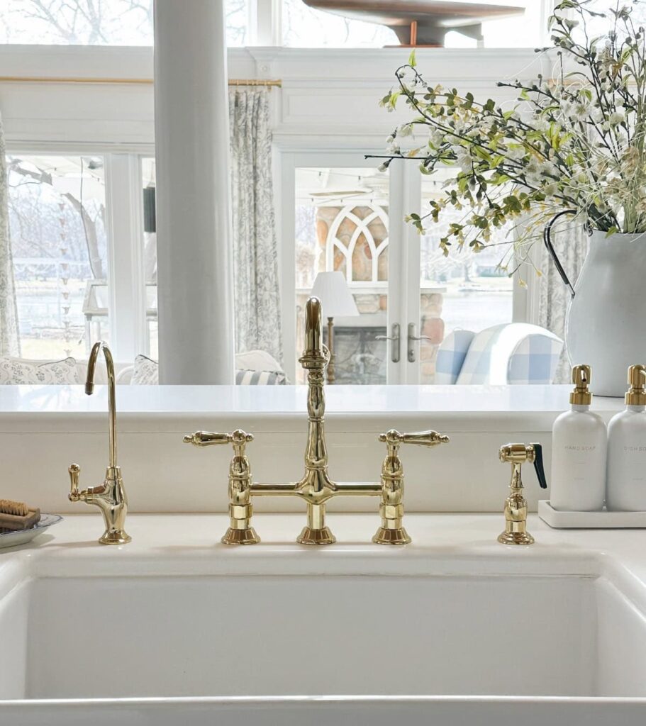 gold faucet on white sink