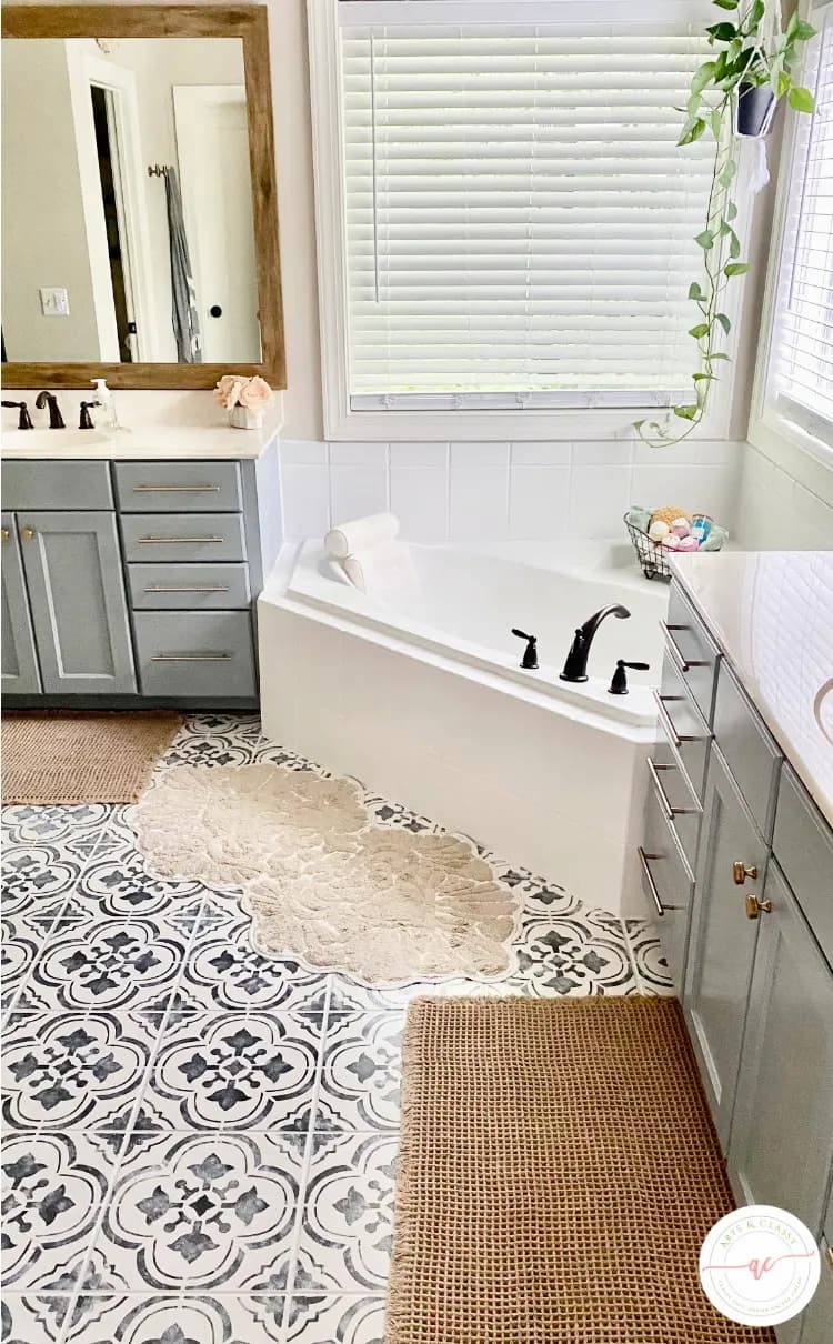 bathroom with blue cabinets white tub