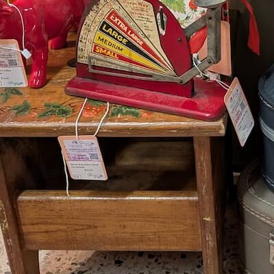 vignette in vintage booth with suitcases, bench, and books