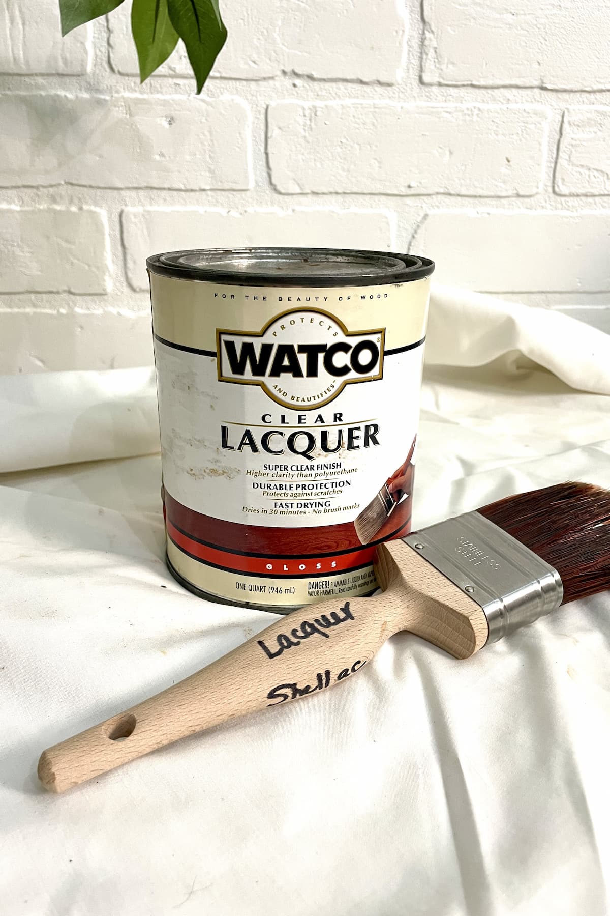 can of lacquer and paint brush