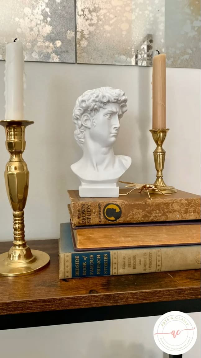 bust on books with candlesticks