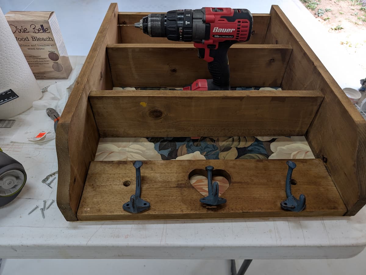 wood shelf with heart detail and hooks