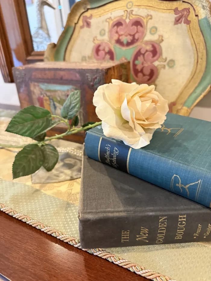 stack of books with rose