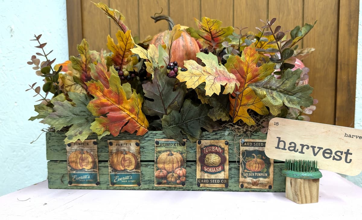 floral arrangement in pumpkin seed box