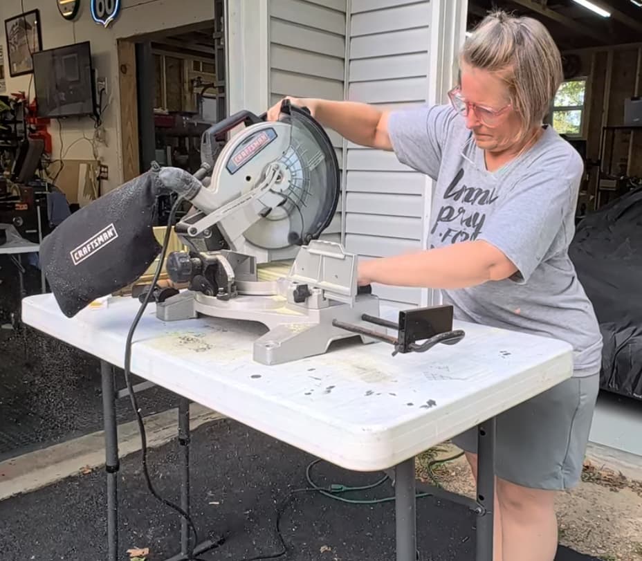 using saw to cut wood