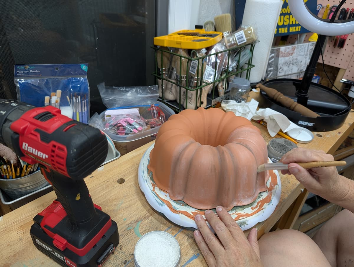 Applying dixie belle grunge to wax on bundt pan pumpkin