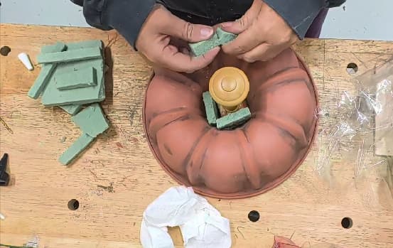 filling in around stem of bundt pan pumpkin with floral foam