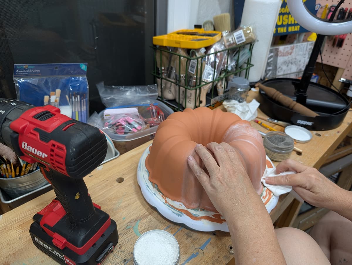 wipe away excess wax on bundt pan pumpkin