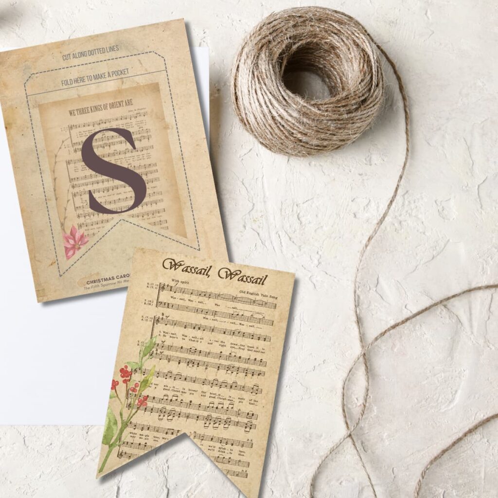 Printable Christmas Carol alphabet banner with pocket pennants featuring Christmas hymn sheet music, botanical artwork, letters A-Z, numbers, and punctuation.